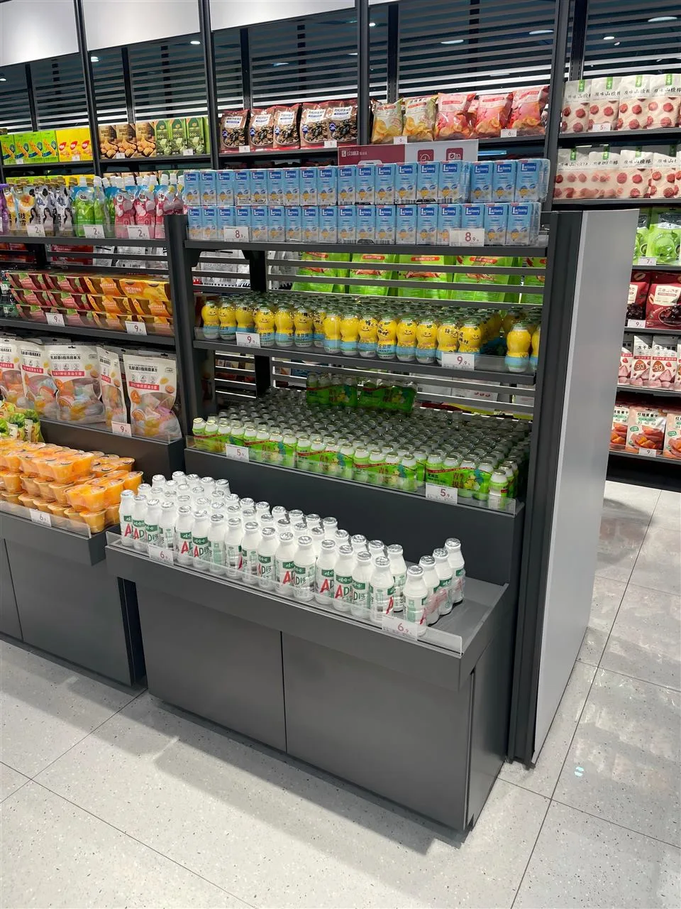 Low Gray Merchandise Table with Stepped Product Rows — reference view 2 of 10