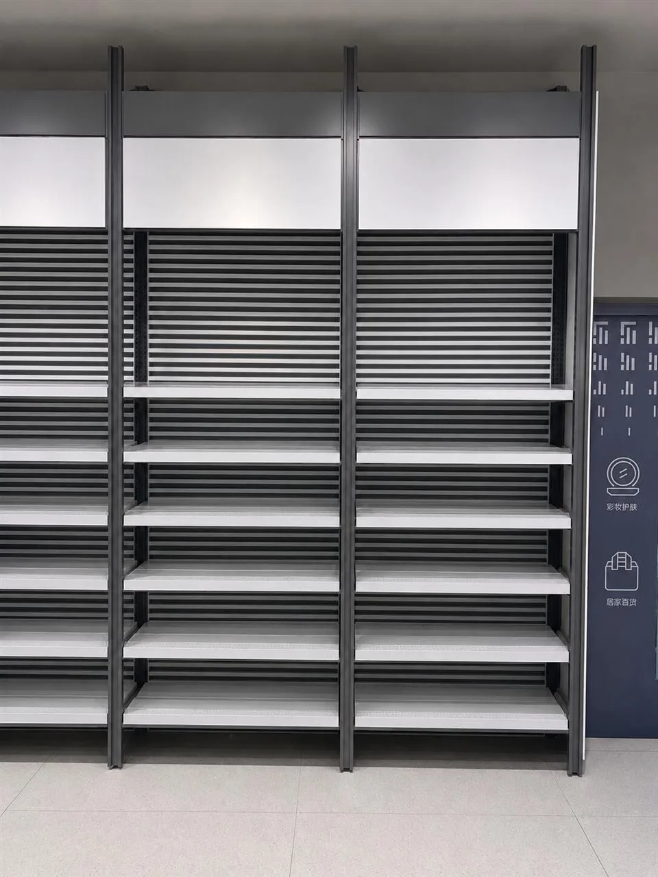 Low Gray Merchandise Table with Stepped Product Rows — reference view 4 of 10