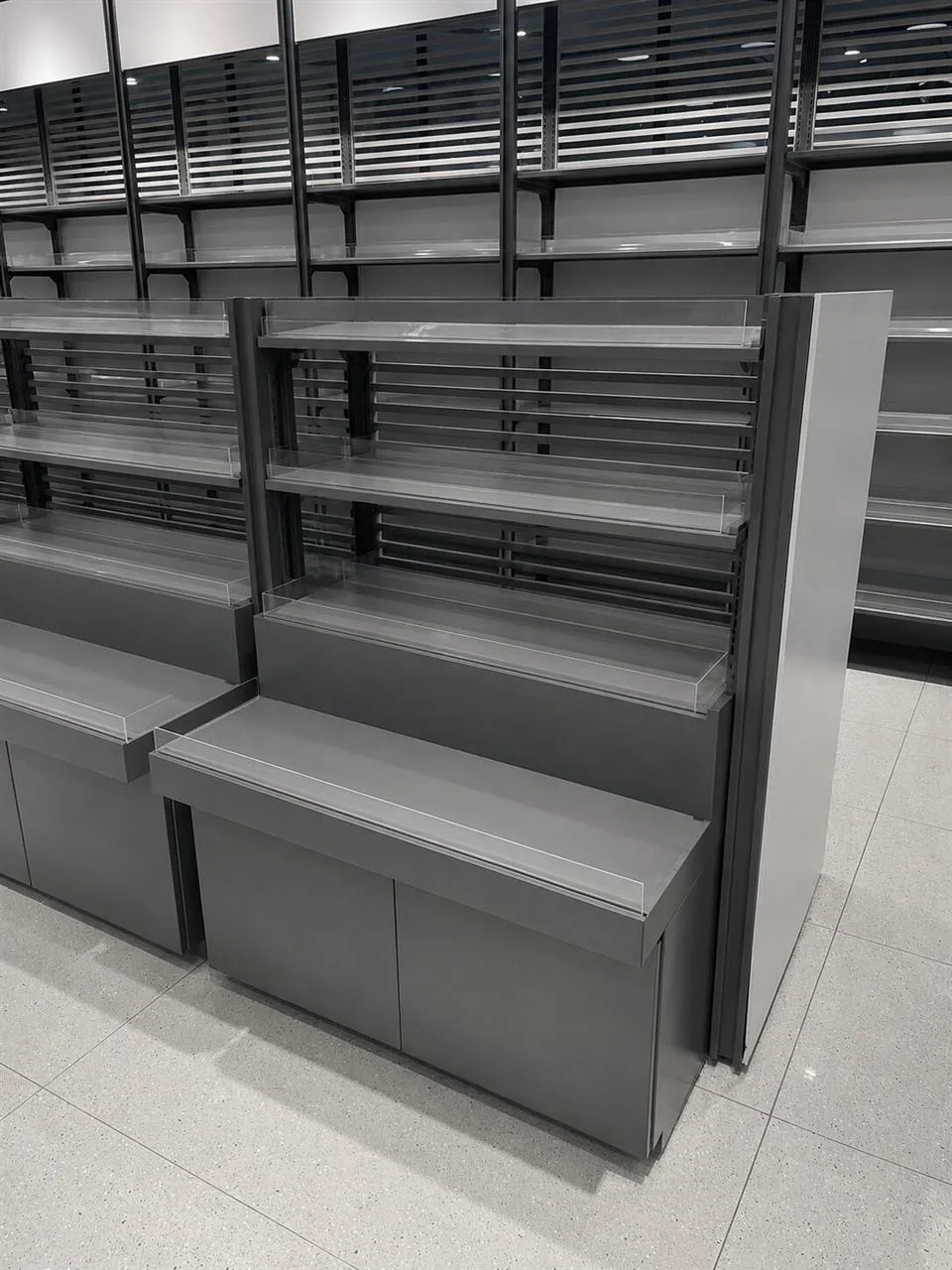 Low Gray Merchandise Table with Stepped Product Rows — reference view 5 of 10