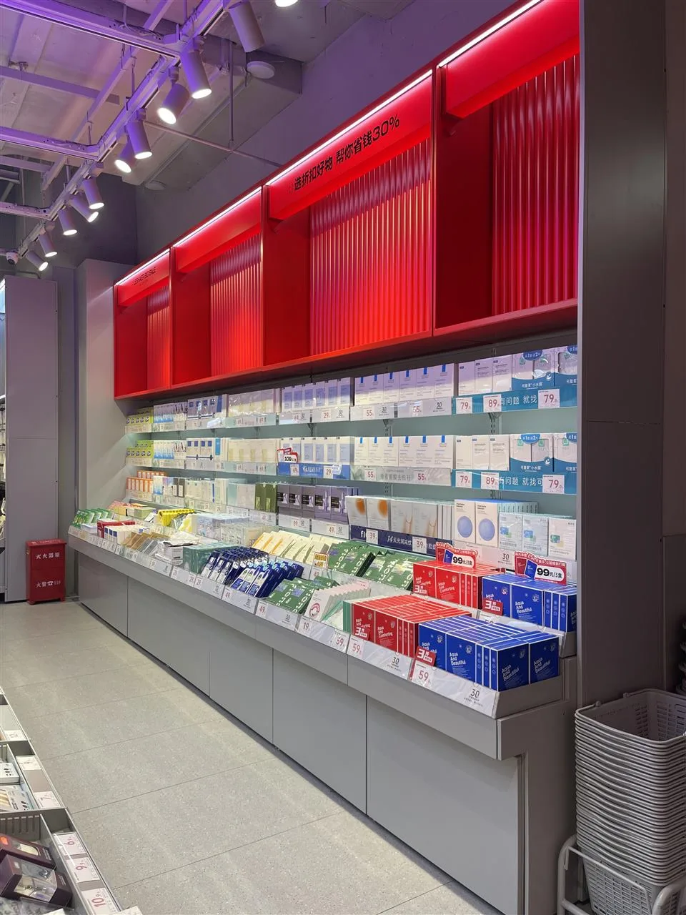 Long Gray Product Wall under Red Graphic Panels