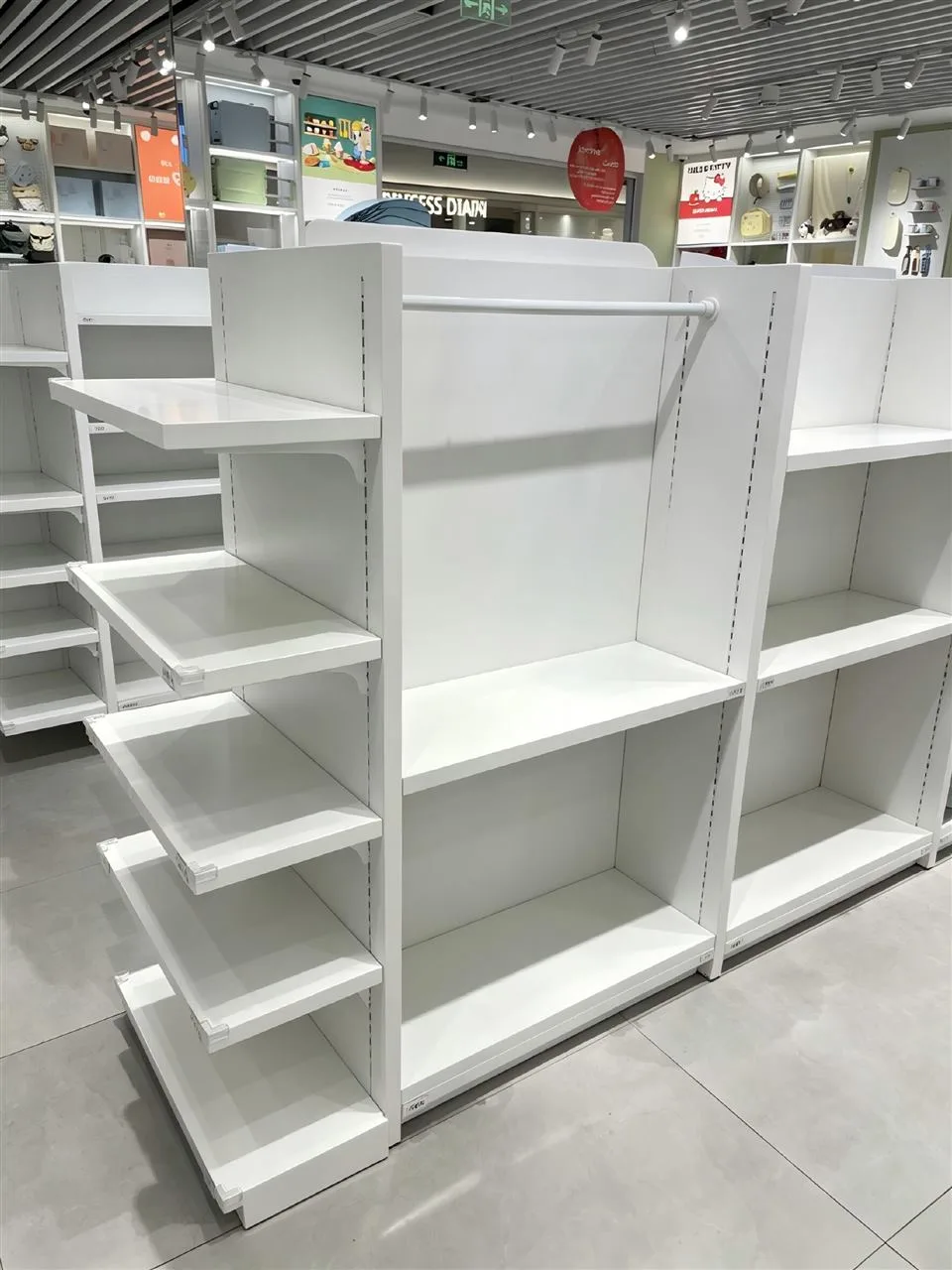 White Product Wall with Large Graphic Panels — reference view 5 of 9