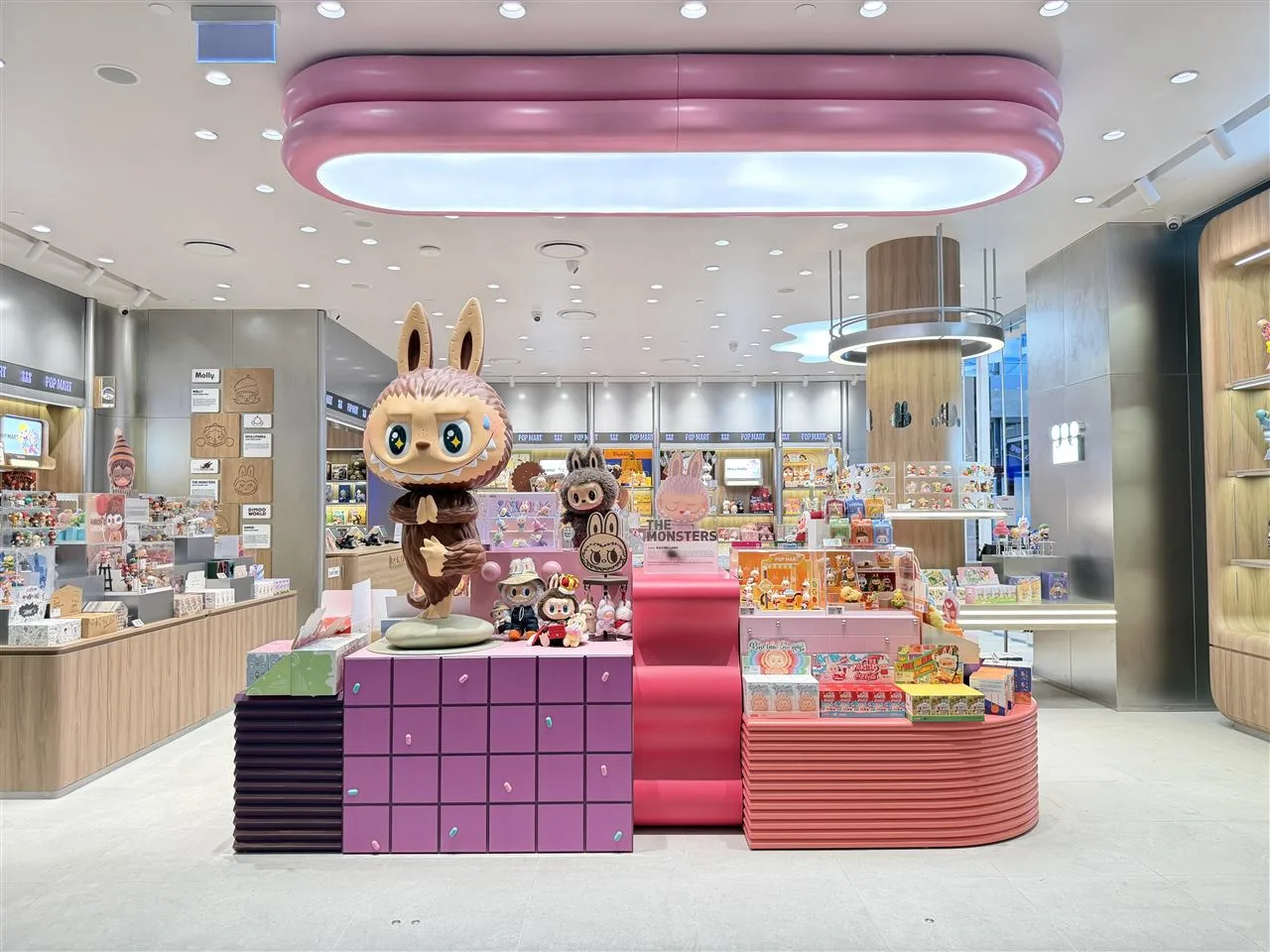 Pale Toy Storefront with Broad Illuminated Fascia — reference view 2 of 8