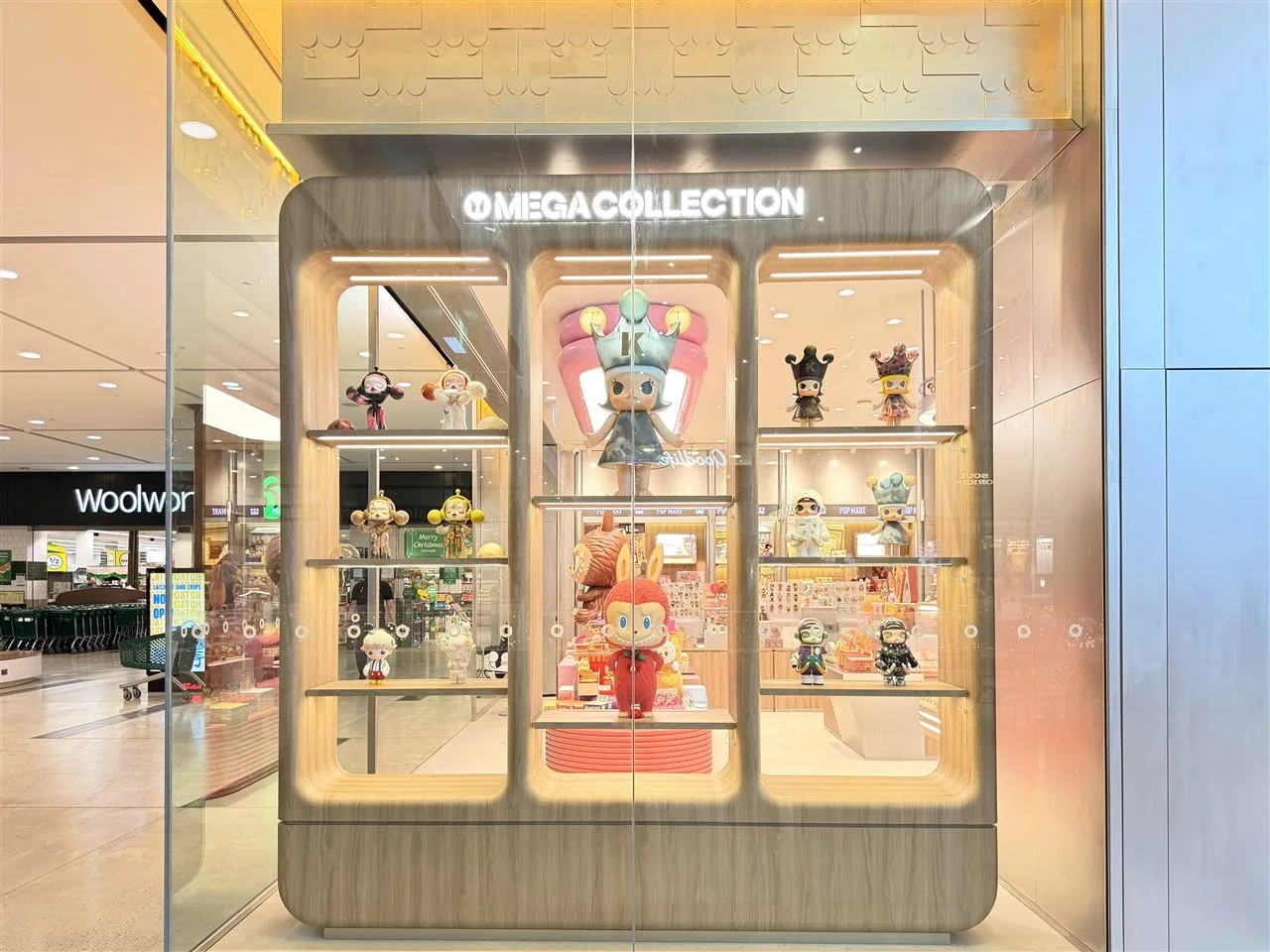 Pale Toy Storefront with Broad Illuminated Fascia — reference view 3 of 8