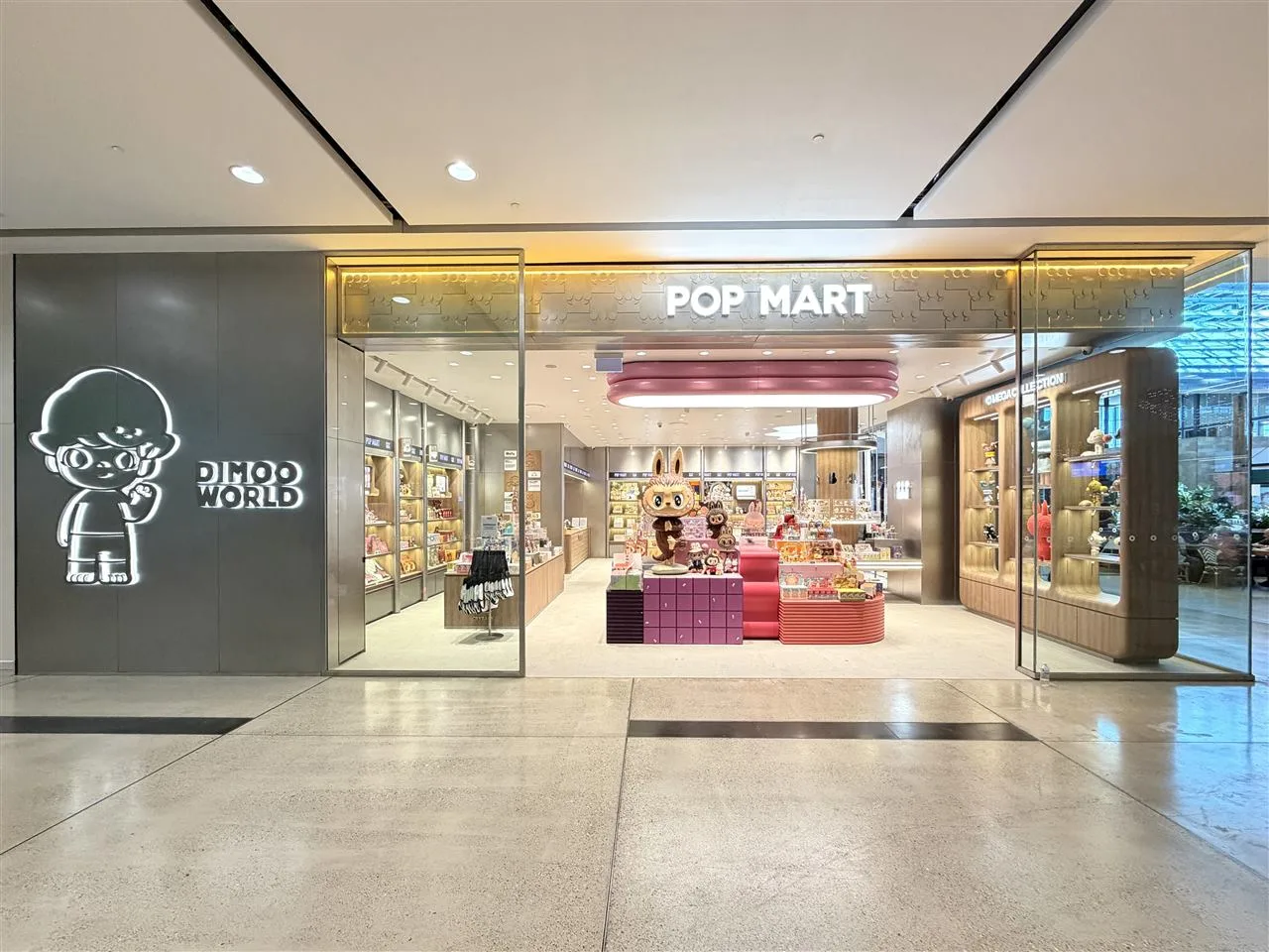 Pale Toy Storefront with Broad Illuminated Fascia — reference view 4 of 8