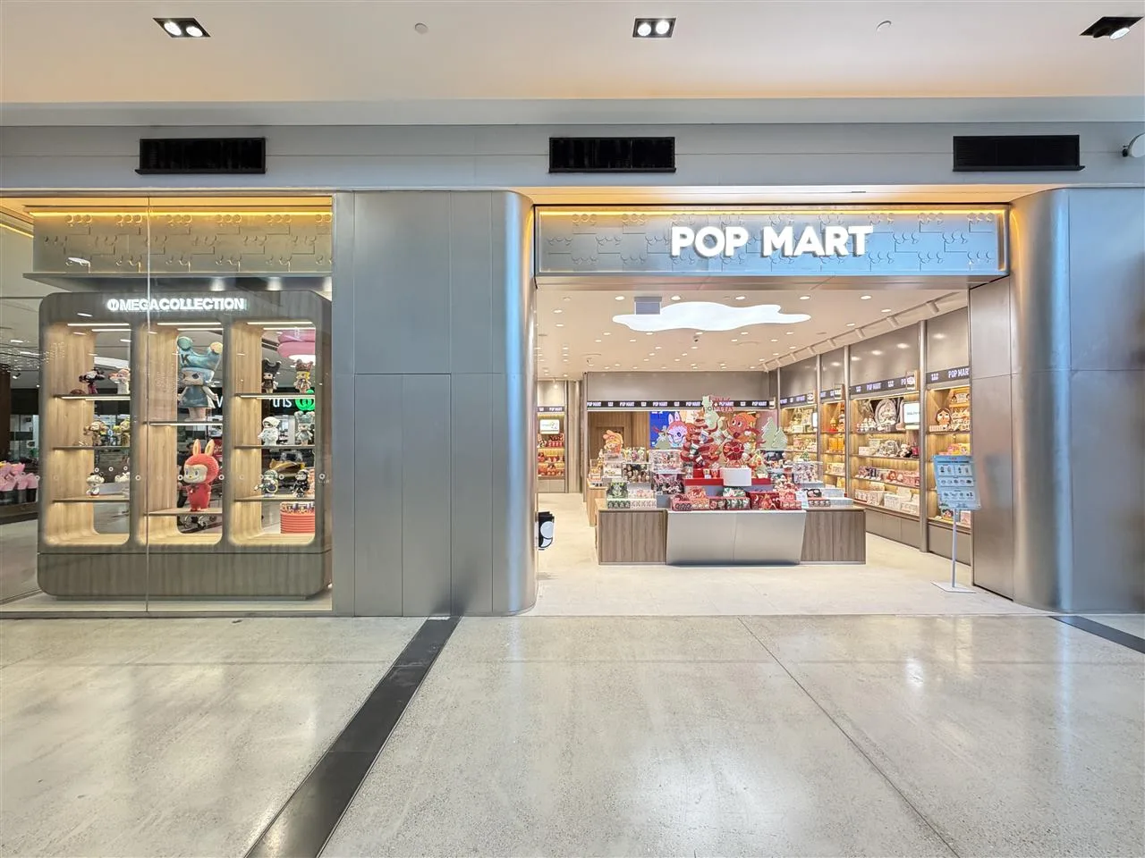 Pale Toy Storefront with Broad Illuminated Fascia — reference view 8 of 8